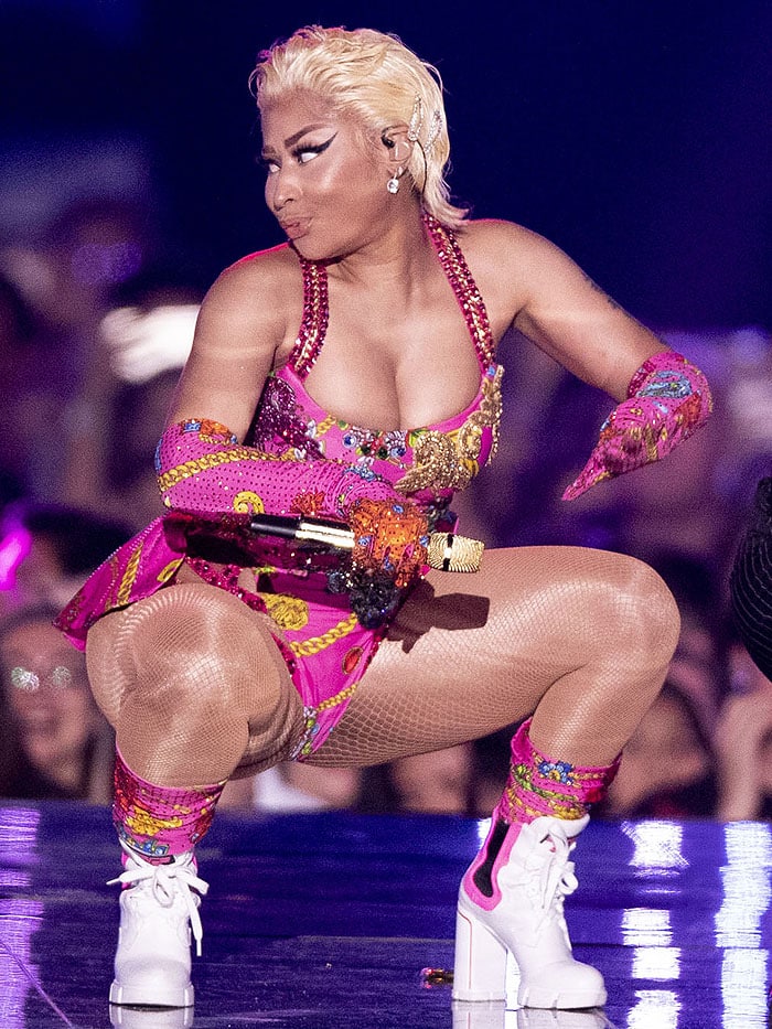 Nicki Minaj in a custom Versace pink printed bodysuit with matching gloves and socks and Prada neon-pink-trimmed sporty booties