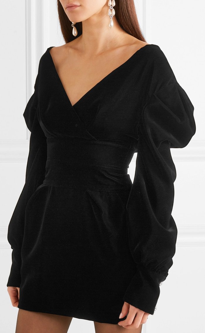 Made from sumptuous black velvet, this off-the-shoulder mini dress is accented with retro puffed sleeves and sparkling crystals.