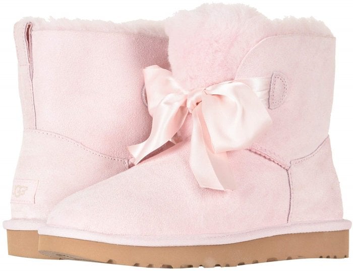 A tonal satin bow adds to the charm of a cozy boot lined and accented with genuine shearling