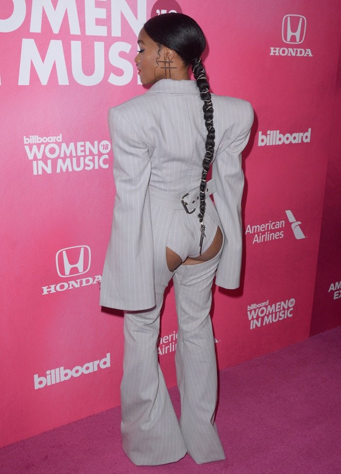Janelle Monáe's daring braided ponytail, styled by Brooklyn-based hairstylist Nikki Nelms, added an edgy touch to her bold Gareth Pugh pinstripe ensemble