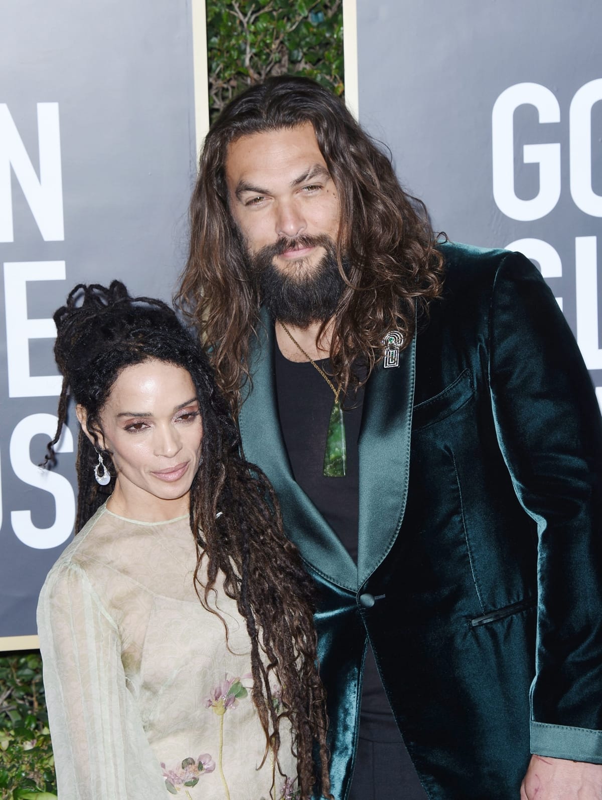 Jason Momoa and Lisa Bonet make a fashionable statement, with Momoa in a velvet green jacket and Bonet in a delicate floral gown