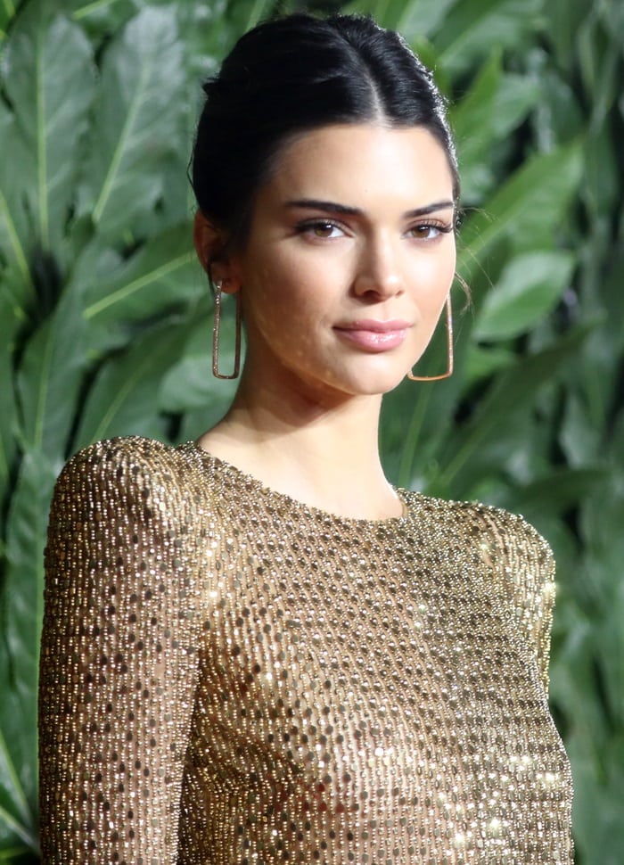 Kendall Jenner styled her signature raven locks into a sleek swept back bun