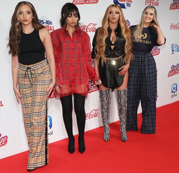 Jade Thirlwall, Leigh-Anne Pinnock, Jesy Nelson, and Perrie Edwards display their distinct styles with plaid trousers, an oversized red plaid shirt, a leather shirt dress with snakeskin thigh-high boots, and checked wide-leg pants