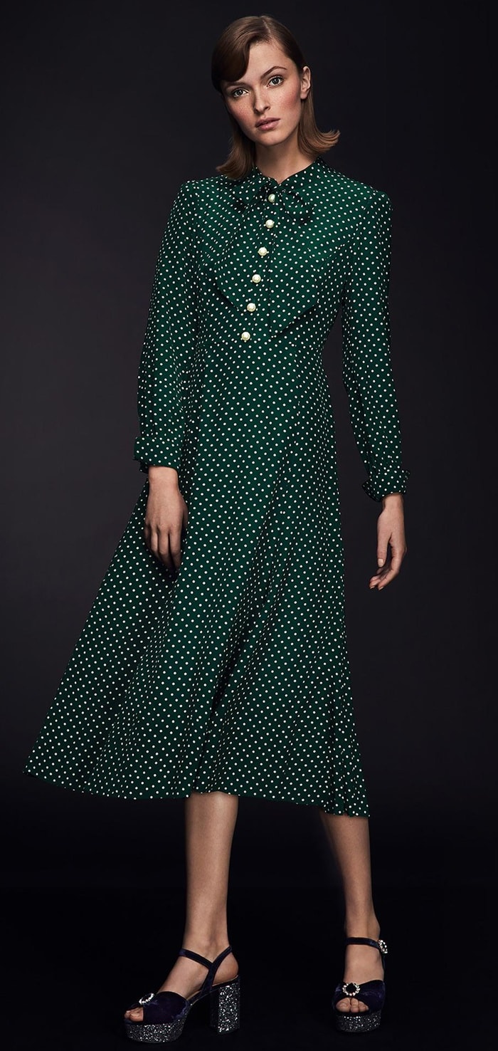 Designed in understated green and cream patterned silk, the fitted waist helps shape an hourglass silhouette, while the pussy-bow detail adds a feminine touch to this button-down design