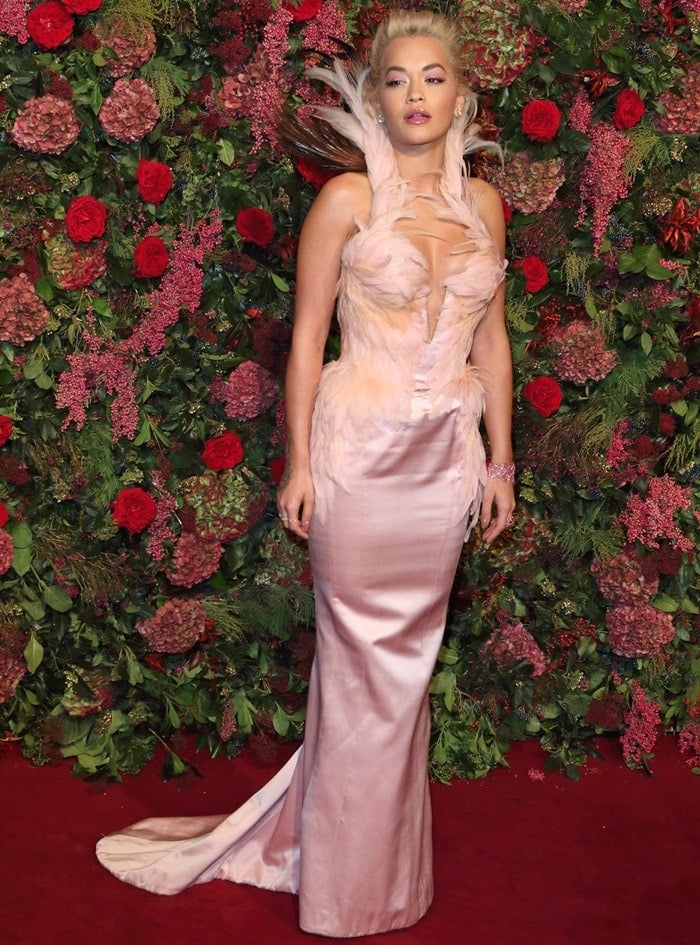 Rita Ora donned a vintage-inspired pale pink Thierry Mugler Couture gown featuring feather embellishments