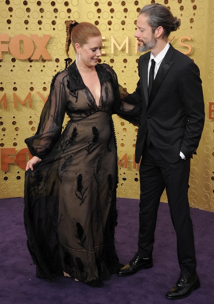 Amy Adams embraced a gothic-romantic aesthetic in a sheer embroidered Fendi Haute Couture gown with a nude slip, while husband Darren Le Gallo kept things classic in a black suit at the 71st Emmy Awards at the Microsoft Theater in Los Angeles on September 22, 2019