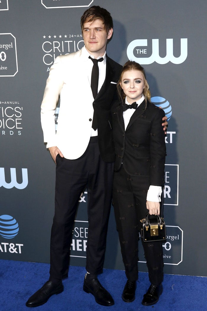 Elsie Fisher posing on the blue carpet with "Eighth Grade" film director, Bo Burnham