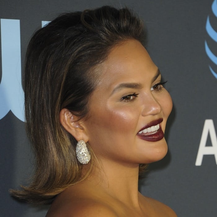 Suffering from a severe hangover, Chrissy Teigen shows off her Jaipur Gems diamond earrings