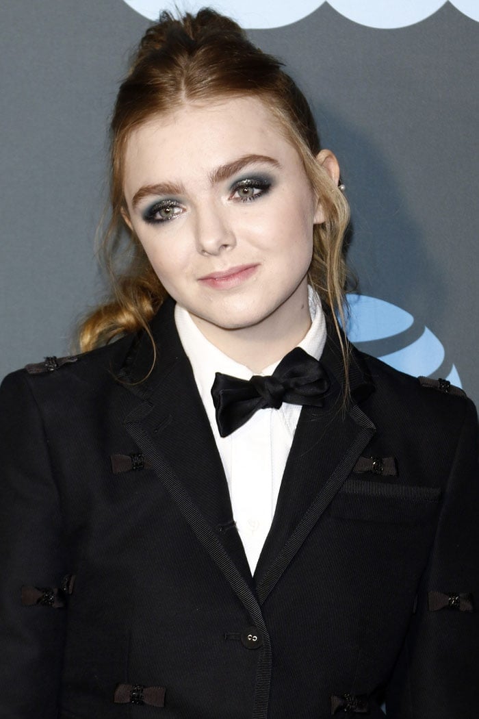 Elsie Fisher wearing silver-and-gray eyeshadow and her strawberry-blonde hair in a messy ponytail