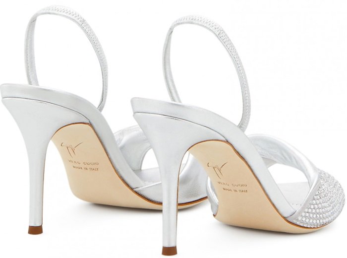 Crafted from cloud gray suede with crystals and silver metallic leather, these sandals feature a crossover detail