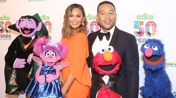 Chrissy Teigen and John Legend posed with Sesame Street characters at the Sesame Street 50th Anniversary Benefit Gala