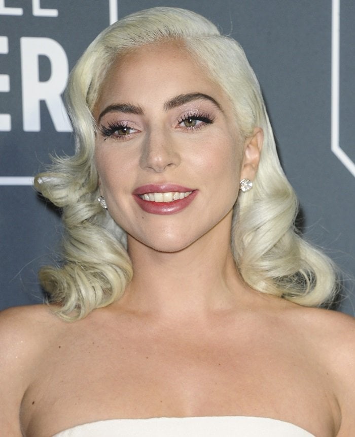 Lady Gaga's elegant curls were swept elegantly across her forehead to show off her Djula earrings