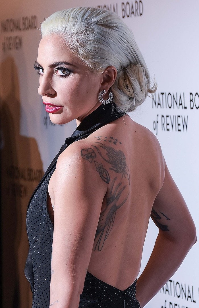 Lady Gaga showed off her back tattoos in a sleeveless black tuxedo dress