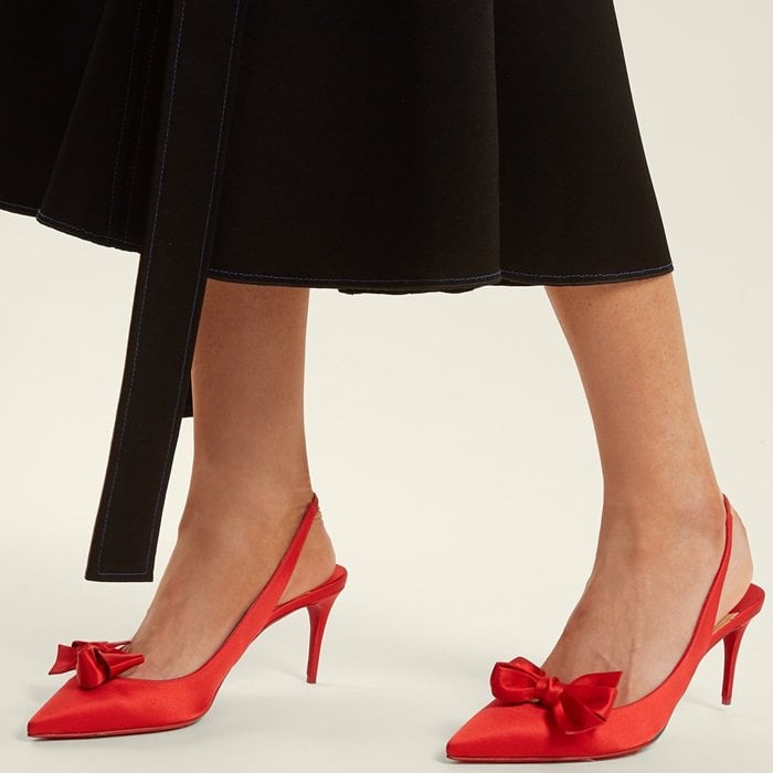 Christian Louboutin’s ruby-red Yasling satin pumps are a bold iteration of the season's favoured slingback style with neat bows at the side of each point toe