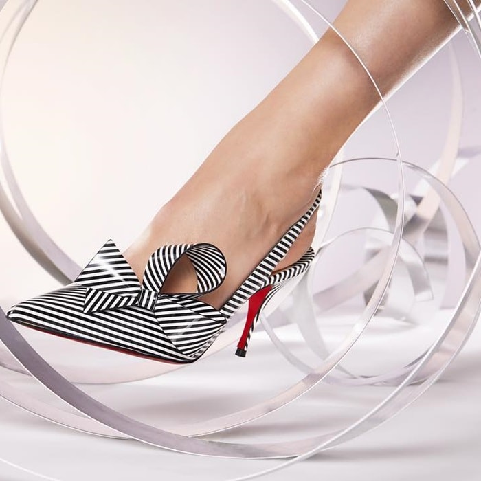 Its low-cut décolleté is adorned with a couture bow and reveals with modernity, the expertise of the Louboutin House