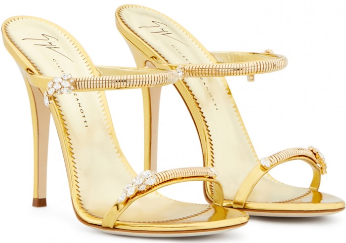 Made from gold shooting patent leather, these sandals are embellished with jewels on the straps