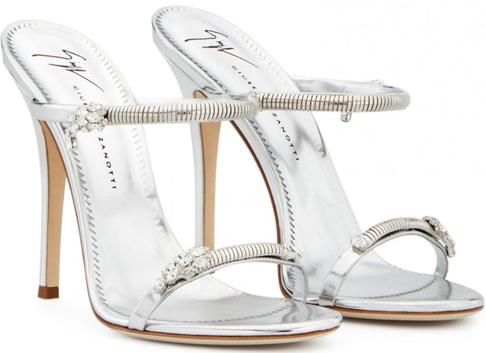 Made from silver shooting patent leather, these sandals are embellished with jewels on the straps