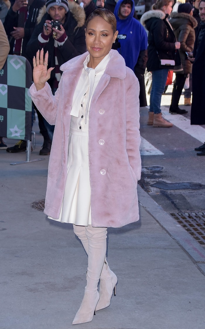 Jada Pinkett Smith in a Christian Dior dress, a Burberry coat, and Balmain boots