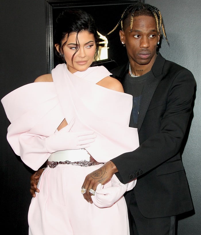 Kylie Jenner donned a pink bubblegum jumpsuit and Travis Scott a Saint Laurent blazer