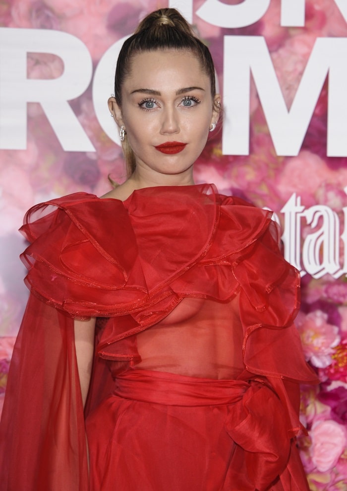 Miley Ray Hemsworth's sleek ponytail and matching red lips