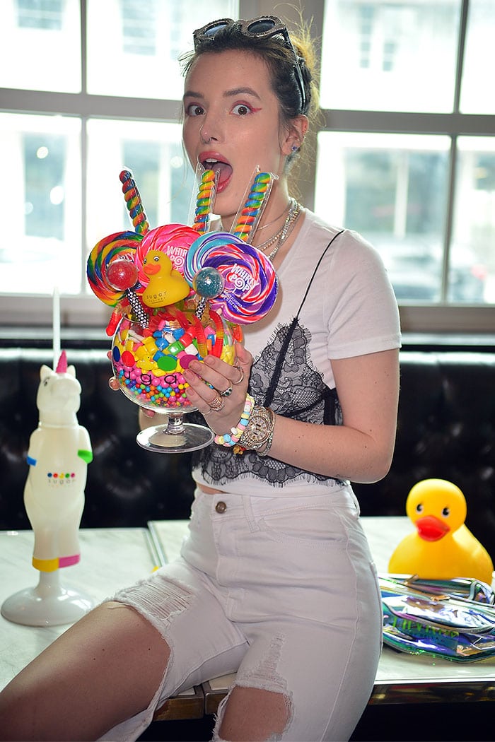 Bella Thorne filling up on colorful candy stacked high in an oversized wine glass