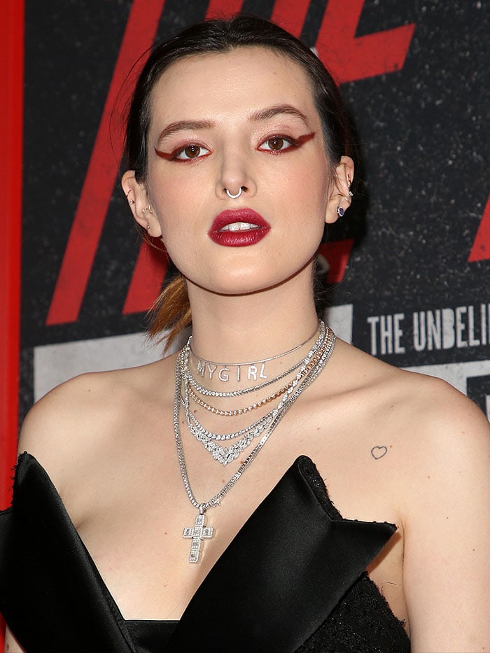 Bella Thorne rocking extreme red winged eyeliner and layers upon layers of necklaces