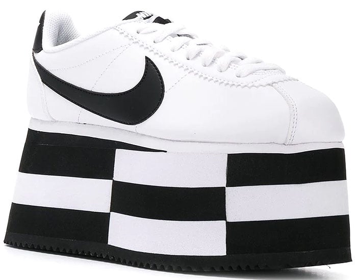 A stylishly striped platform sole gives a literal attitude boost to a sleek sneaker designed in collaboration with iconic sportswear brand Nike