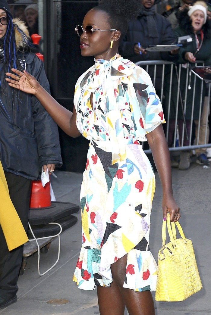 Lupita Nyong’o floral-print keyhole blouse and skirt outside of the Good Morning America studios ahead of her appearance in New York City on March 19, 2019