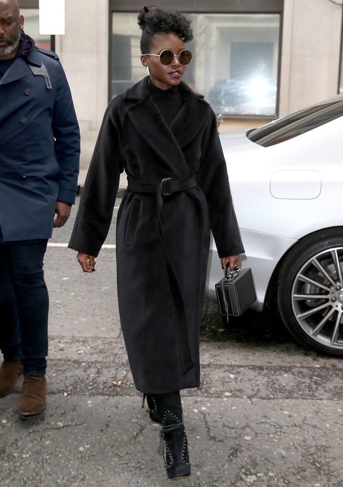 Lupita Nyongo wearing a Max Mara coat and an Ara Vartanian ring after visiting BBC Radio 2 in London, United Kingdom, on March 15, 2019