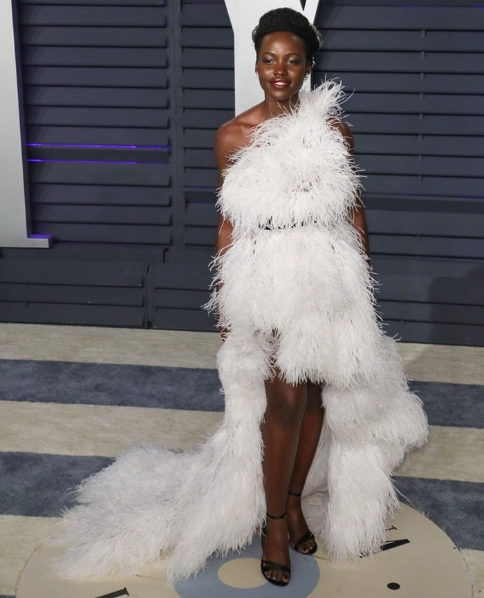 Lupita Nyong’o in a white feathered Oscar de la Renta Fall 2019 dress at the 2019 Vanity Fair Oscar Party at the Wallis Annenberg Center for the Performing Arts in Beverly Hills, California, on February 24, 2019