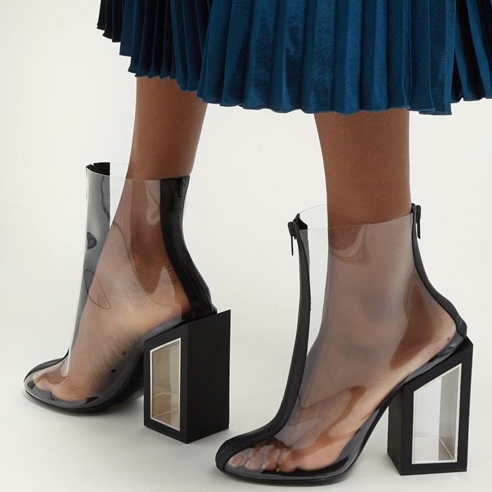 On-trend clear PVC ankle boots featuring a bold cutout block heel for an eye-catching look