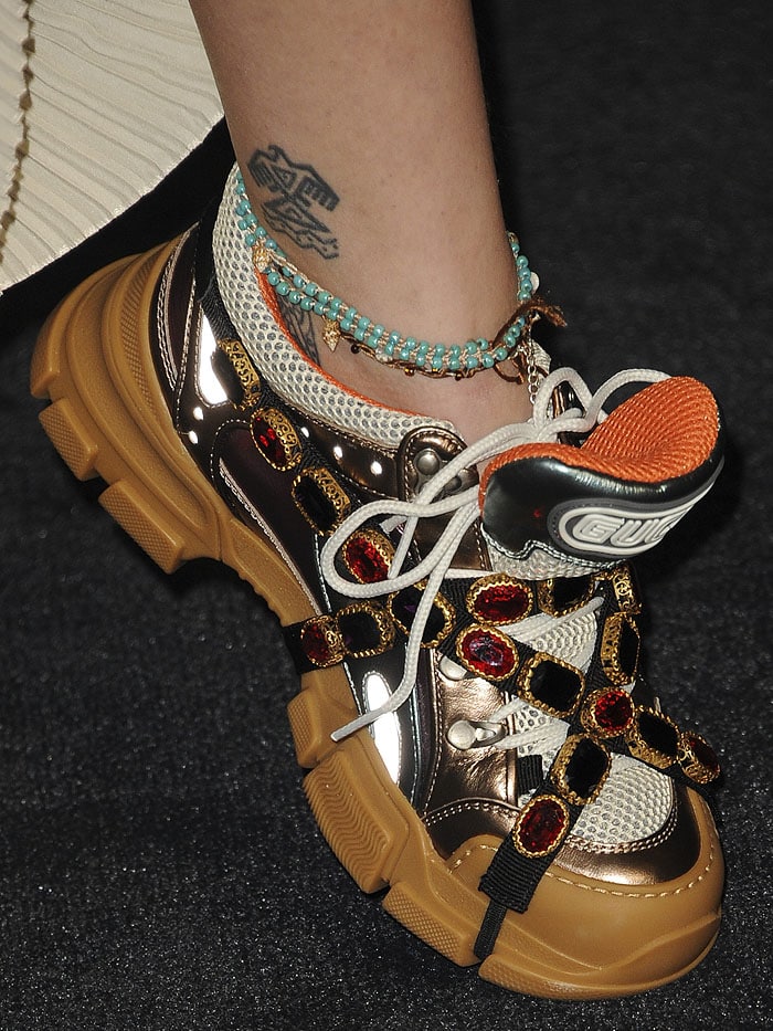 Closeup of Paris Jackson's Gucci ''Flashtrek' crystal-wrapped sneakers and tribal eagle ankle tattoo