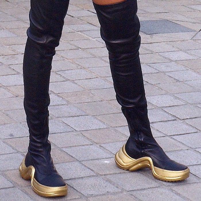 Willow Smith's legs in black-and-gold Louis Vuitton thigh-high sneaker boots
