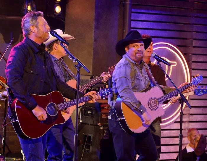 Blake Shelton, whose estimated net worth is $80 million, performing with Garth Brooks at the CMA Awards 2019