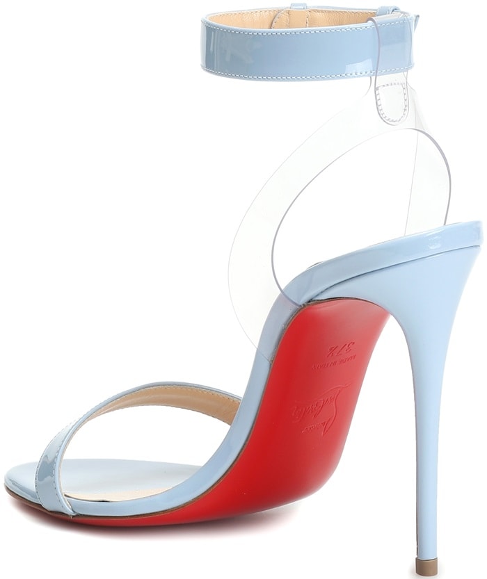 Crafted in Italy from sky blue patent leather, the round-toe design features a transparent slingback ankle strap
