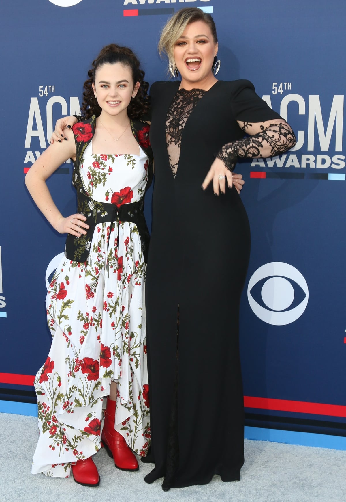 Kelly Clarkson in an Alexander McQueen dress, Yves Saint Laurent earrings, and Balmain shoes with The Voice winner Chevel Shepherd at the 2019 Academy of Country Music Awards