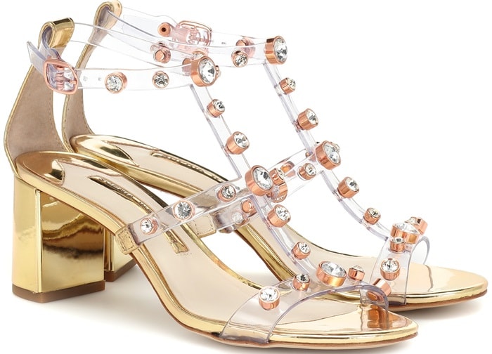 This high-octane silhouette has been crafted from golden leather with transparent PVC straps punctuated by shimmering crystal embellishments in a rose gold-tone