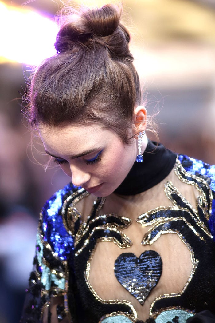Lily Collins wearing electric blue eyeliner and Cartier diamond-and-sapphire earrings