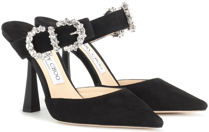 These elegant black goat skin Smokey 100 pumps from Jimmy Choo feature a pointed toe, an ankle strap with a crystal baroque buckle, a branded insole and a high kick heel