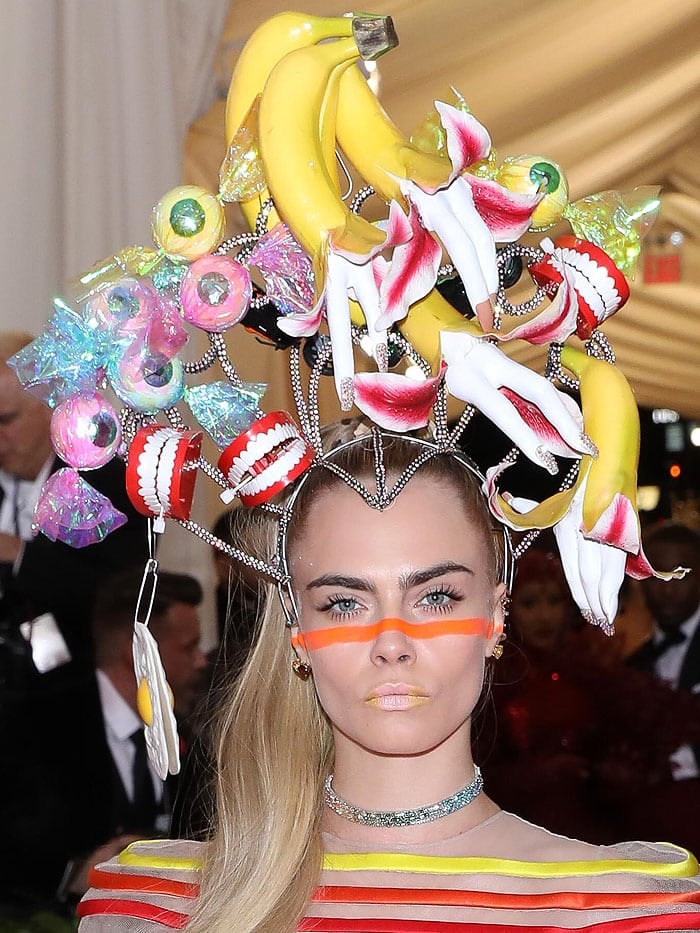 Cara Delevingne wearing a crazy banana teeth headpiece