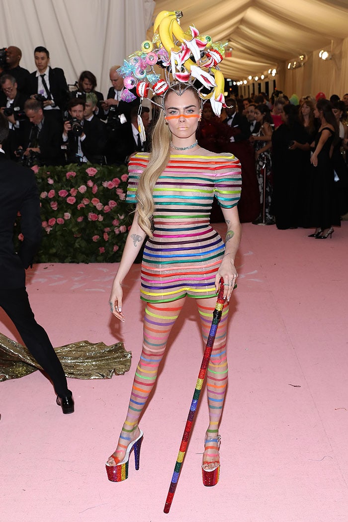 Cara Delevingne wearing a Dior Haute Couture rainbow-striped romper at the 2019 Met Gala
