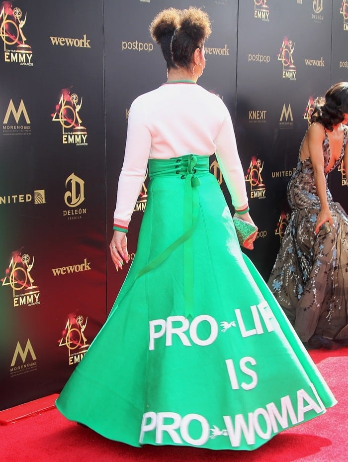 Joy Villa's bright green skirt features the line “Pro-life is pro-woman”