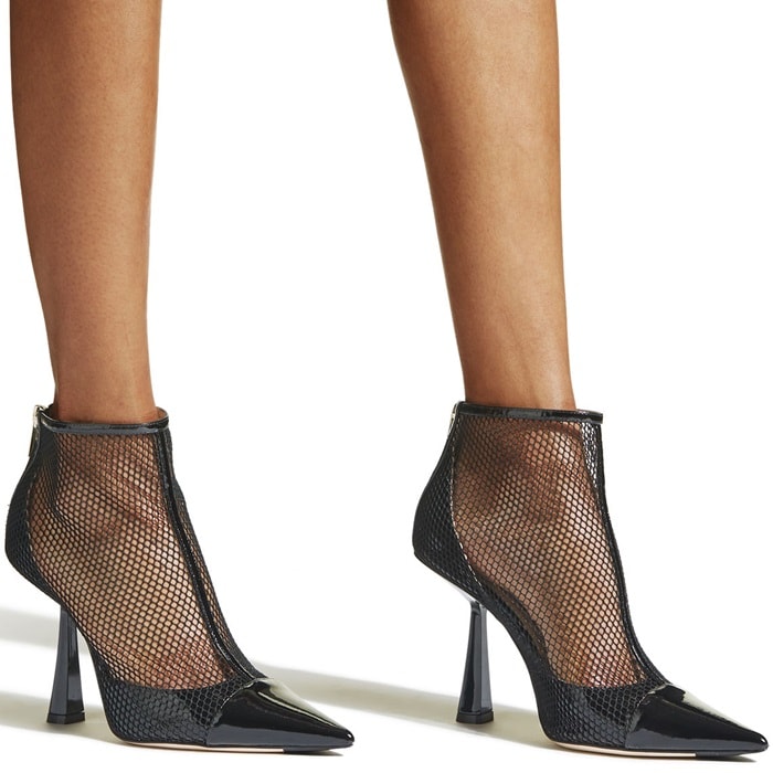 Fishnet mesh, a patent T-strap and flared heel make this pointy cap-toe pump look daringly provocative