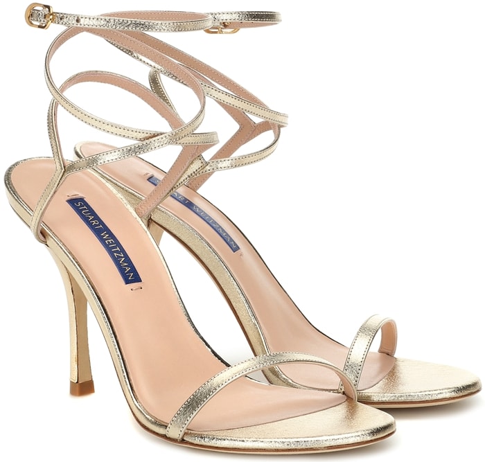 Accentuate your evening look in the Merinda sandals featuring a metallic or patent leather and a wraparound ankle strap