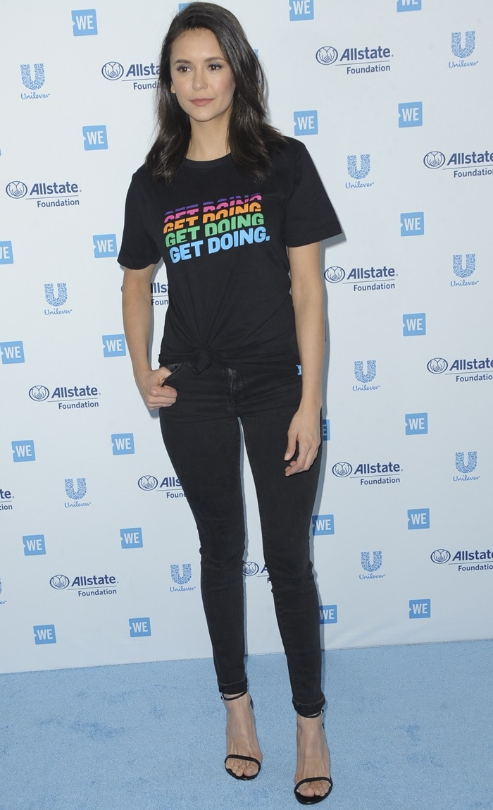 Nina Dobrev in skinny jeans and a Get Doing slogan t-shirt