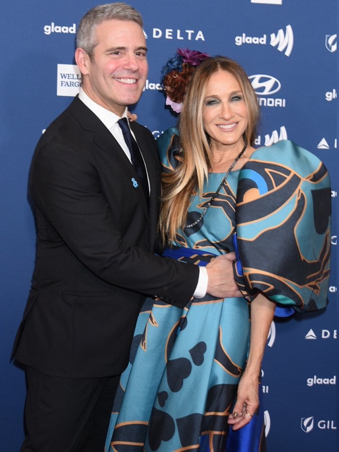 Andy Cohen and Sarah Jessica Parker pose on the red carpet, with Parker stunning in a voluminous Elie Saab gown adorned with puff sleeves and abstract heart patterns at the 2019 GLAAD Media Awards