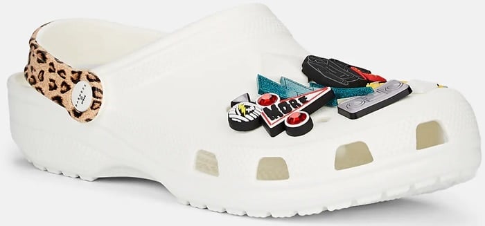 These rubber clogs are embellished with multicolored assorted rubber pyramid spikes and pop culture-inspired charms