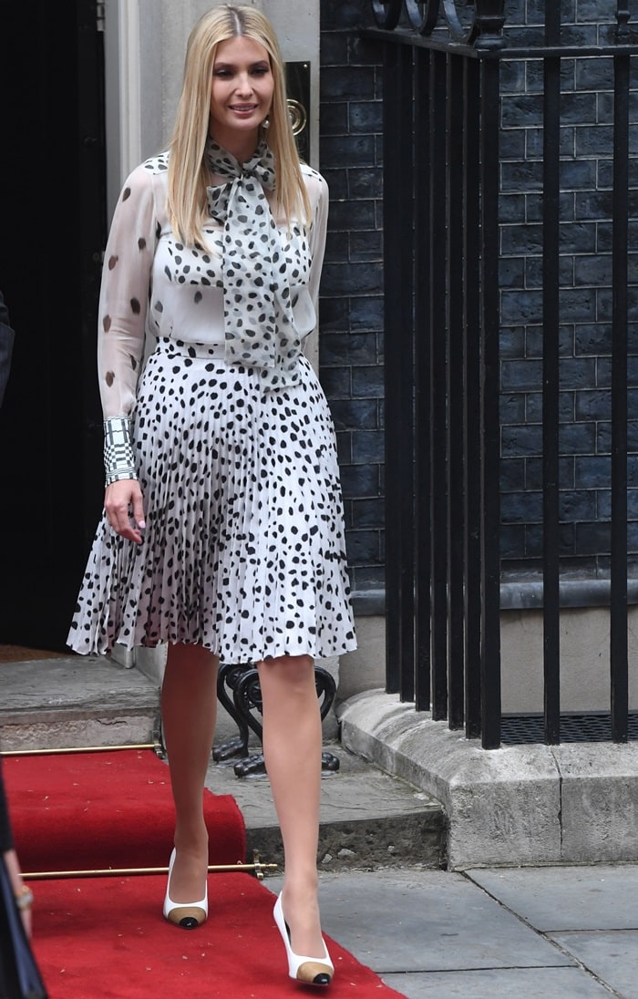 Ivanka Trump exudes polished elegance in a monochrome Burberry ensemble, pairing a dalmatian-print blouse and pleated skirt with sleek Annalise cap-toe pumps