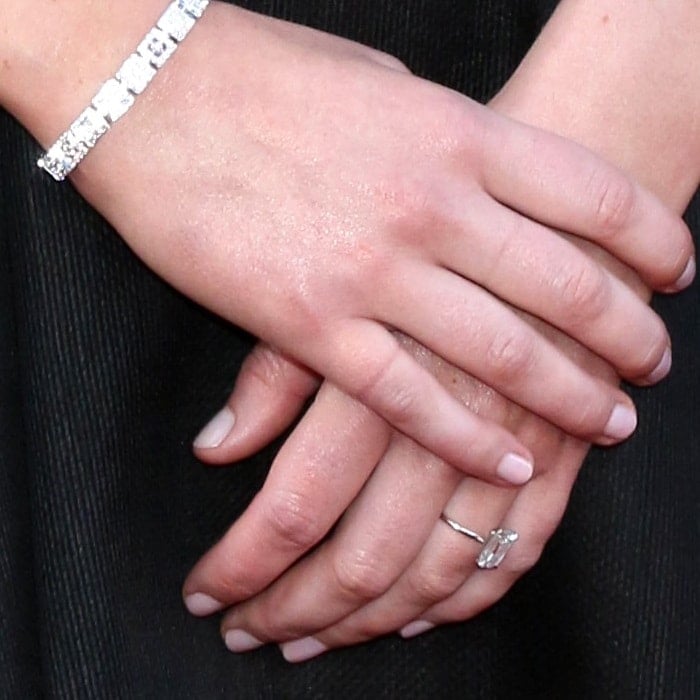 Jennifer Lawrence's emerald-cut diamond engagement ring on a delicate band