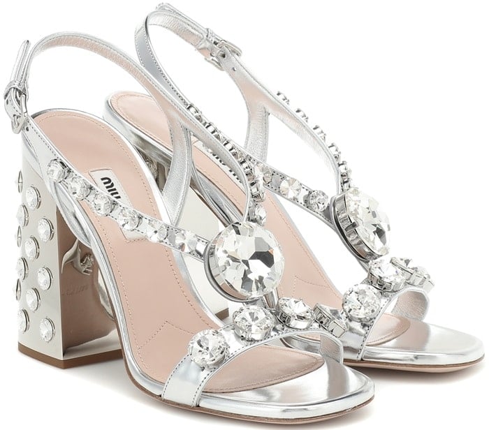 Crafted in Italy from glossy metallic silver leather, the embellished style is set on a mirrored block heel, creating eye-catching glimmer with every step